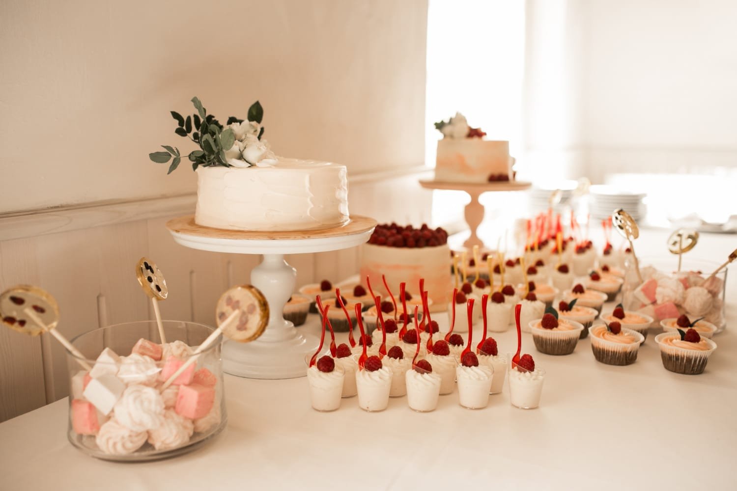 Elegant multi tier white wedding cake featuring a classic bride and groom cake topper.