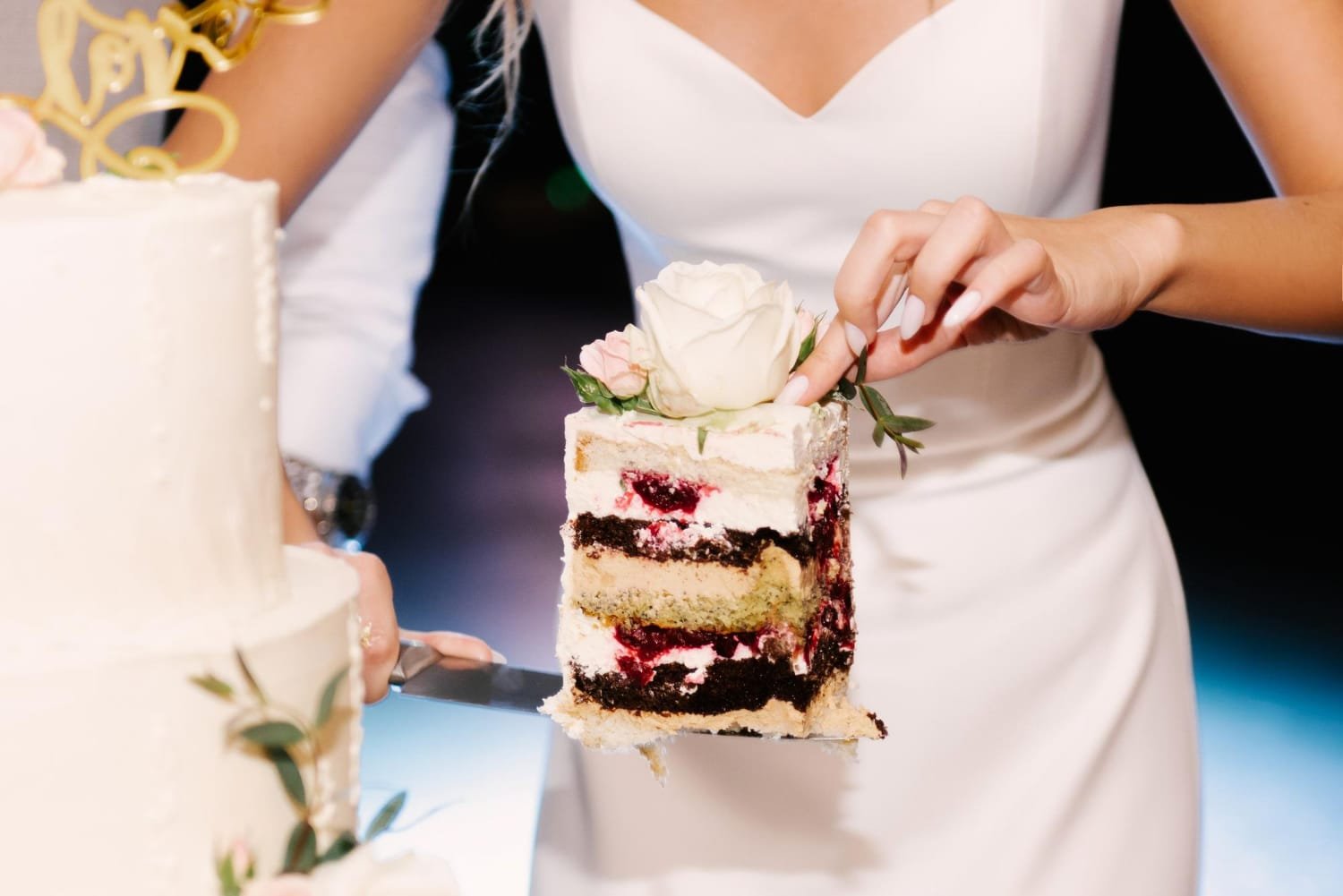 Unique wedding cake ideas featuring a luxury dark colored cake with gold leaf details.