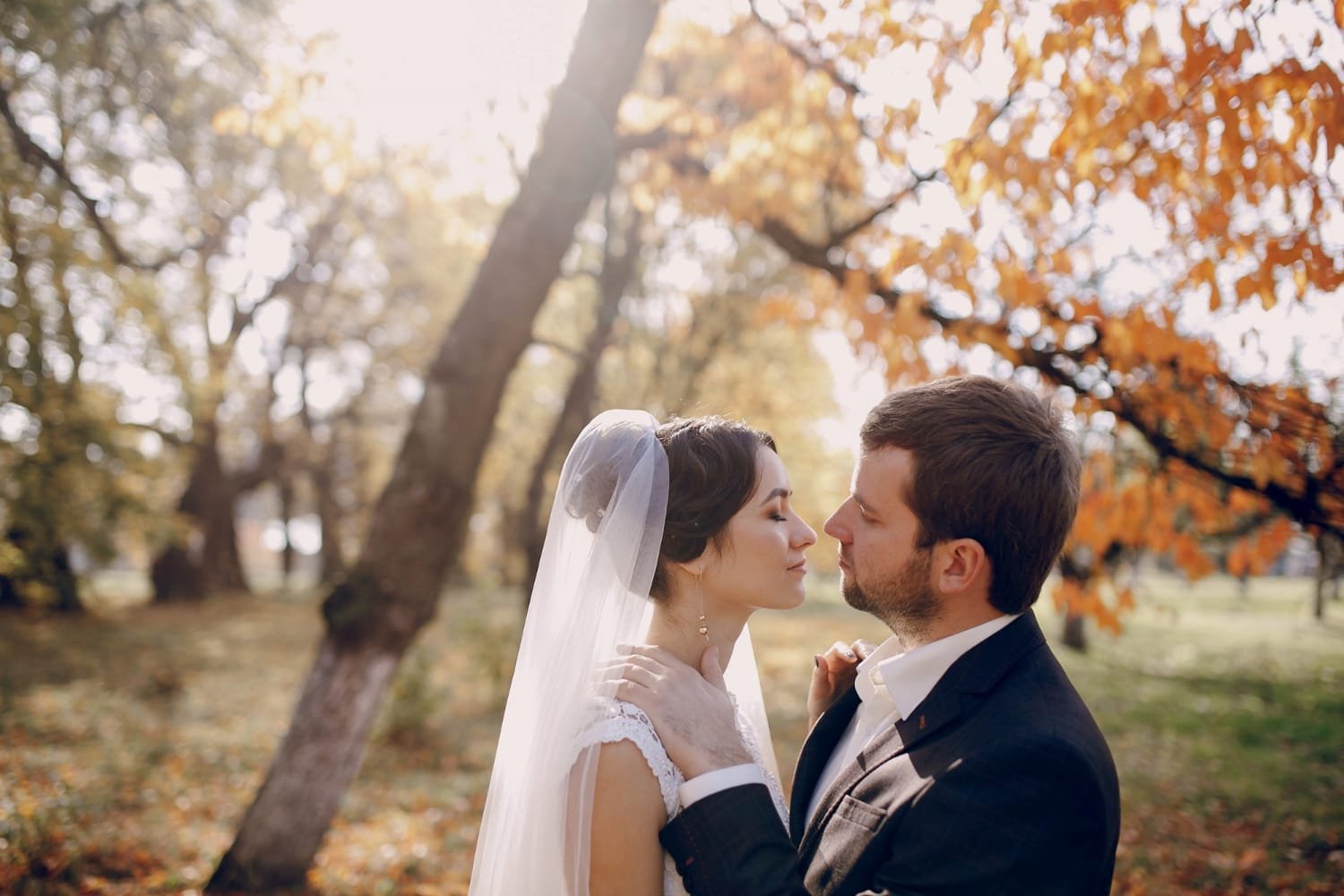 November Wedding Checklist: What to Confirm 30 Days Before the Wedding 7 Bride and groom face to face in autumn foliage ahead of the wedding rehearsal. November Wedding Checklist
