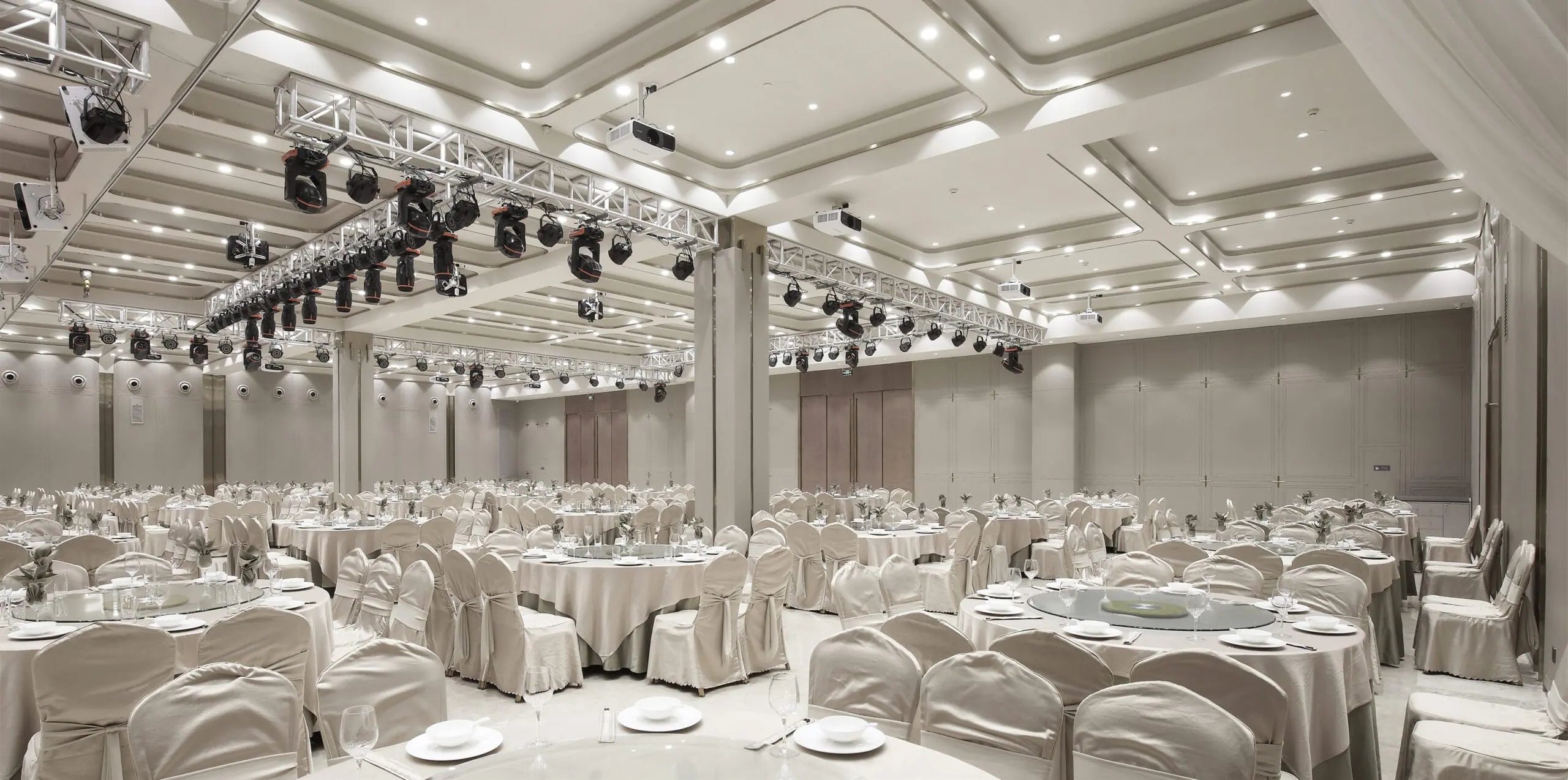 Elegant ballroom reception venue set with round tables for a winter wedding