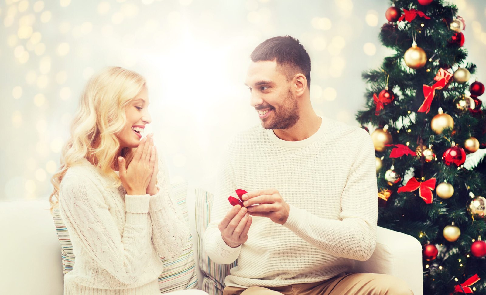 man giving woman engagement ring for christmas