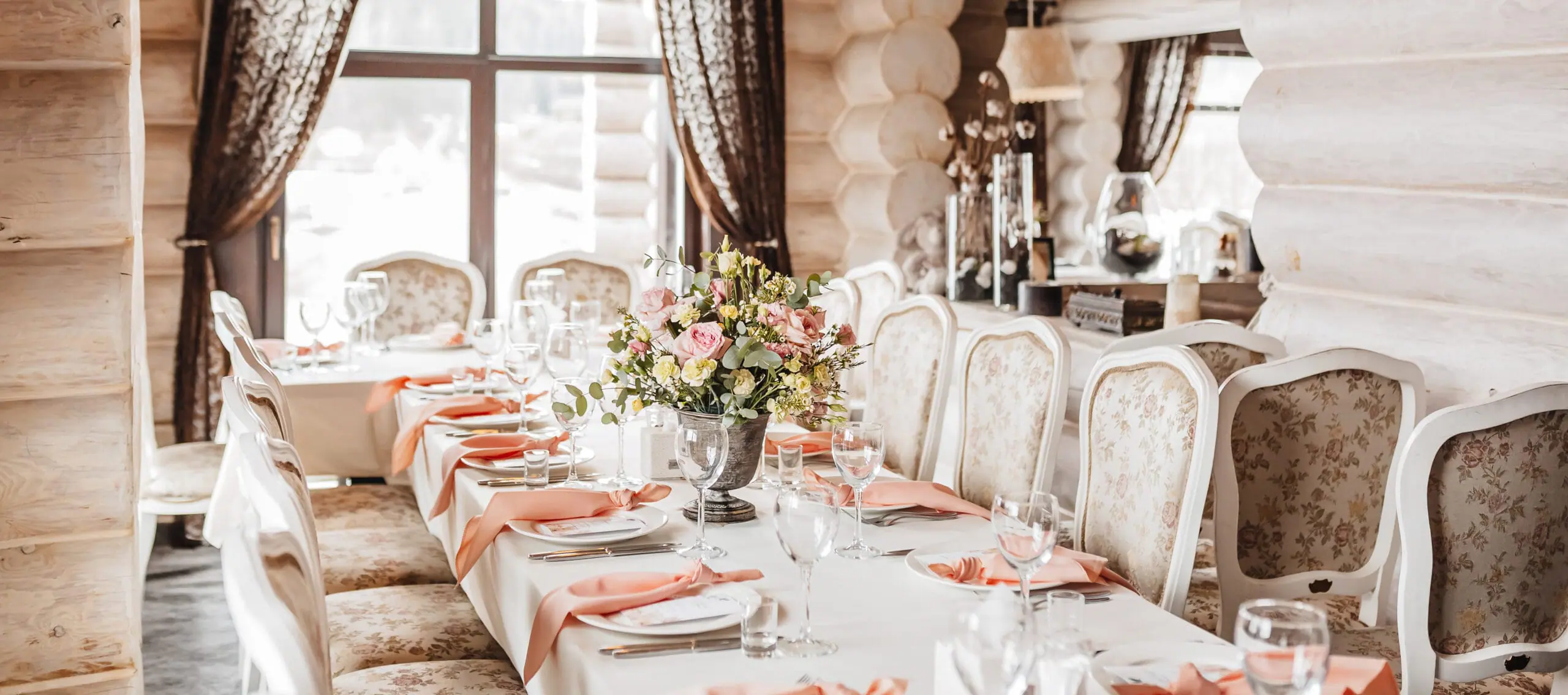 Elegant wedding reception table setting with pastel linens and fine dining details