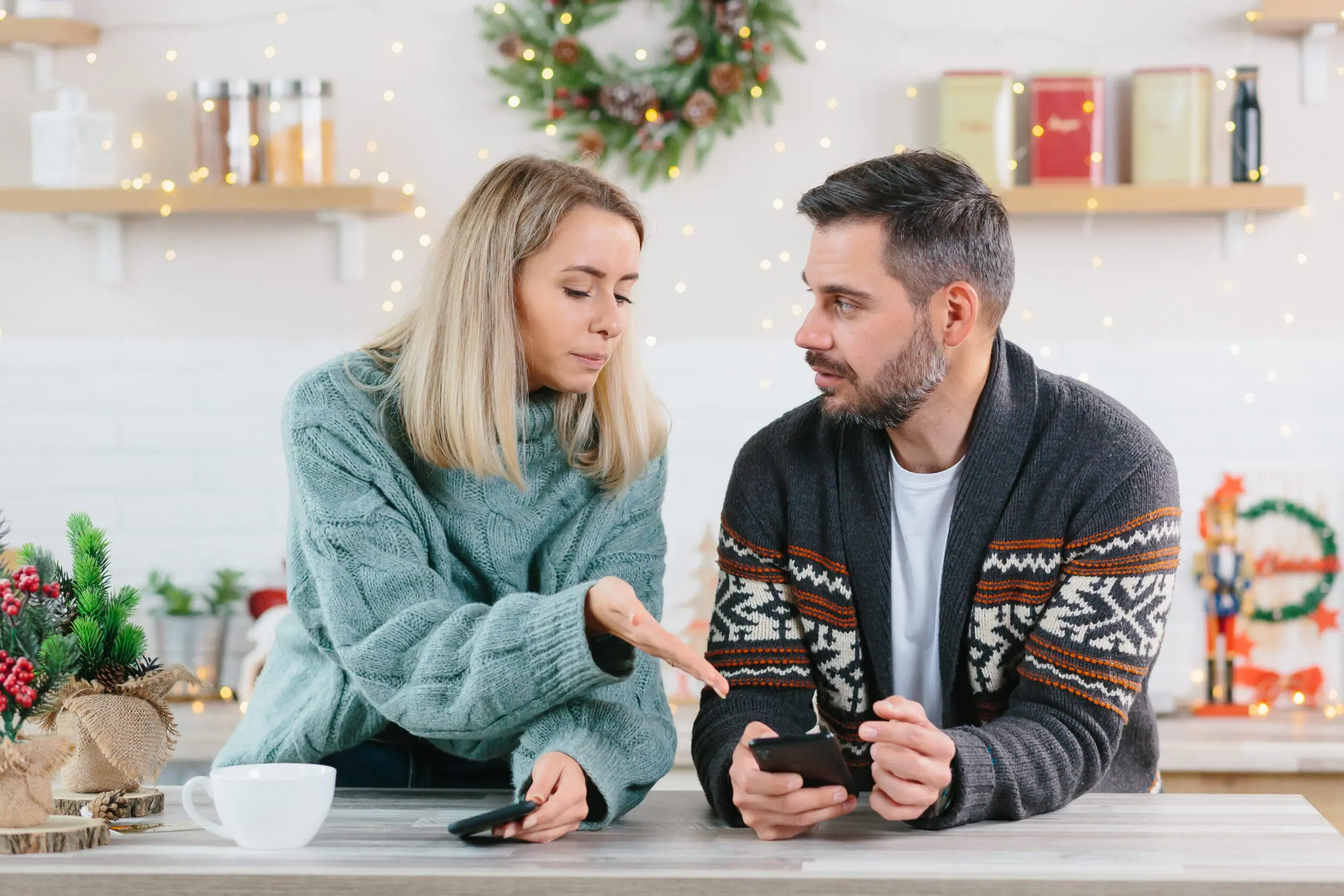 December Wedding Budget: Holiday Premiums and Off-Season Savings Explained 8 Couple arguing over mobile phones. December Wedding Cost