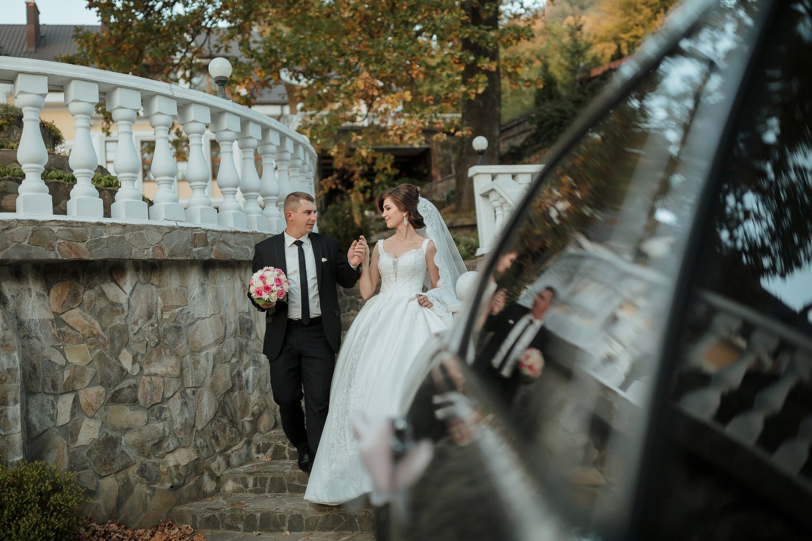 Bride and groom walking down a stone staircase, illustrating a common accessible wedding venue red flag