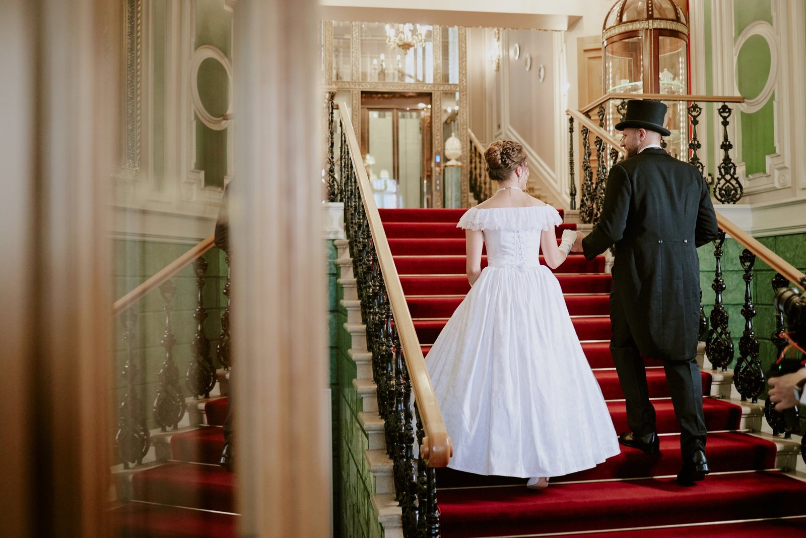 Guests ascending a grand staircase at a wedding venue, a common accessibility red flag for guests with mobility needs