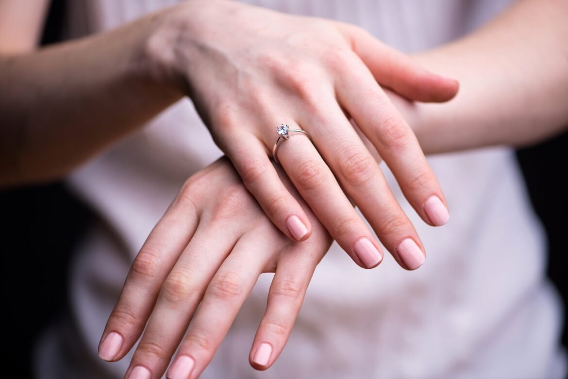 Elegant close-up of a diamond engagement ring on a bride's hand, symbolizing the value worth protecting with ring insurance