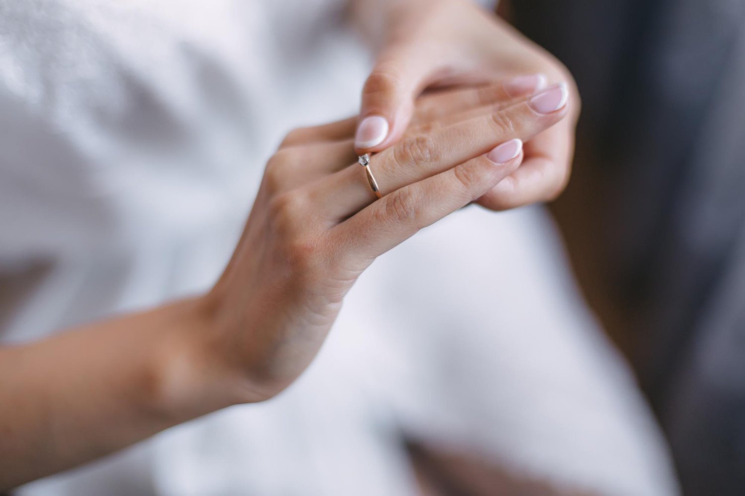 Engagement Ring Insurance: Hidden Costs and Fees the Quote May Not Show 14 Closeup of a gold engagement ring with a diamond on the bride's hand with a delicate manicure