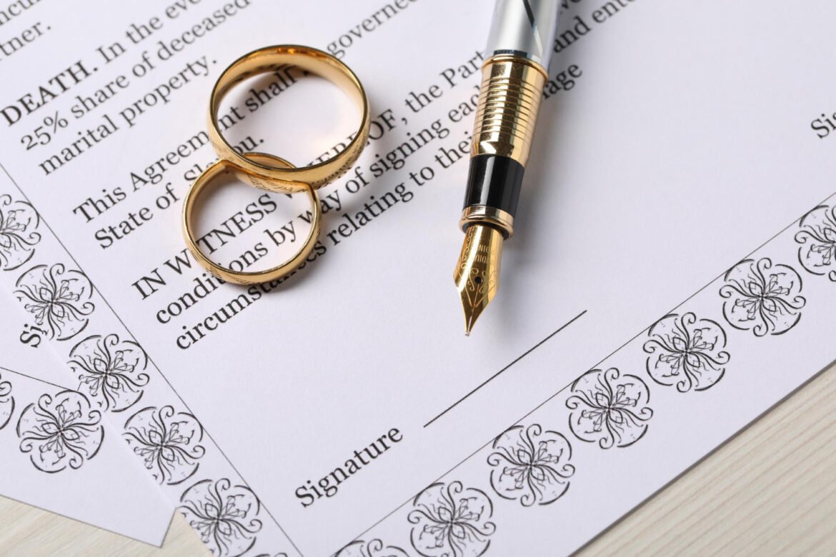 Marriage certificate document with gold wedding rings and fountain pen, symbolizing name change paperwork after marriage