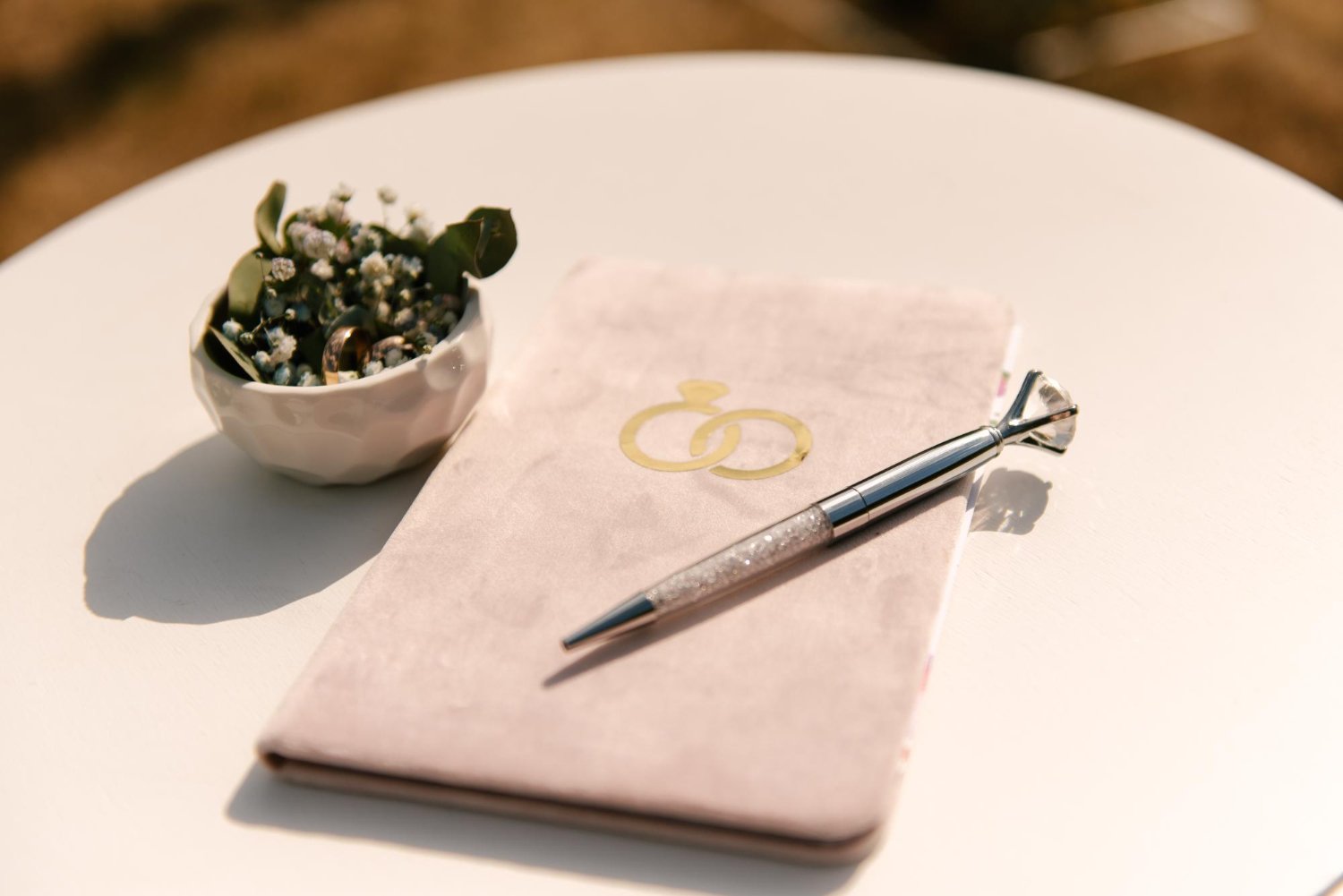 Name Change After Marriage: Costs, Deadlines, and the Paperwork Nobody Explains 15 Pink marriage registration book with wedding rings and a decorative pen