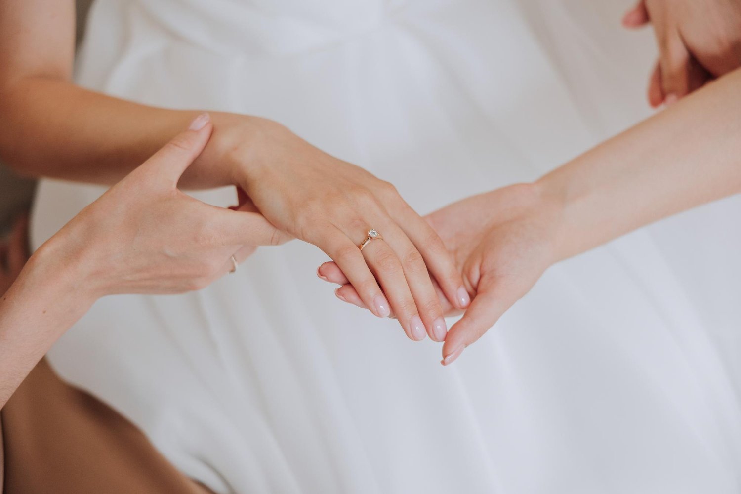 Engagement Ring Insurance: Hidden Costs and Fees the Quote May Not Show 13 Tender close-up of a woman's hand with an engagement ring and manicure, reflecting the elegance worth insuring