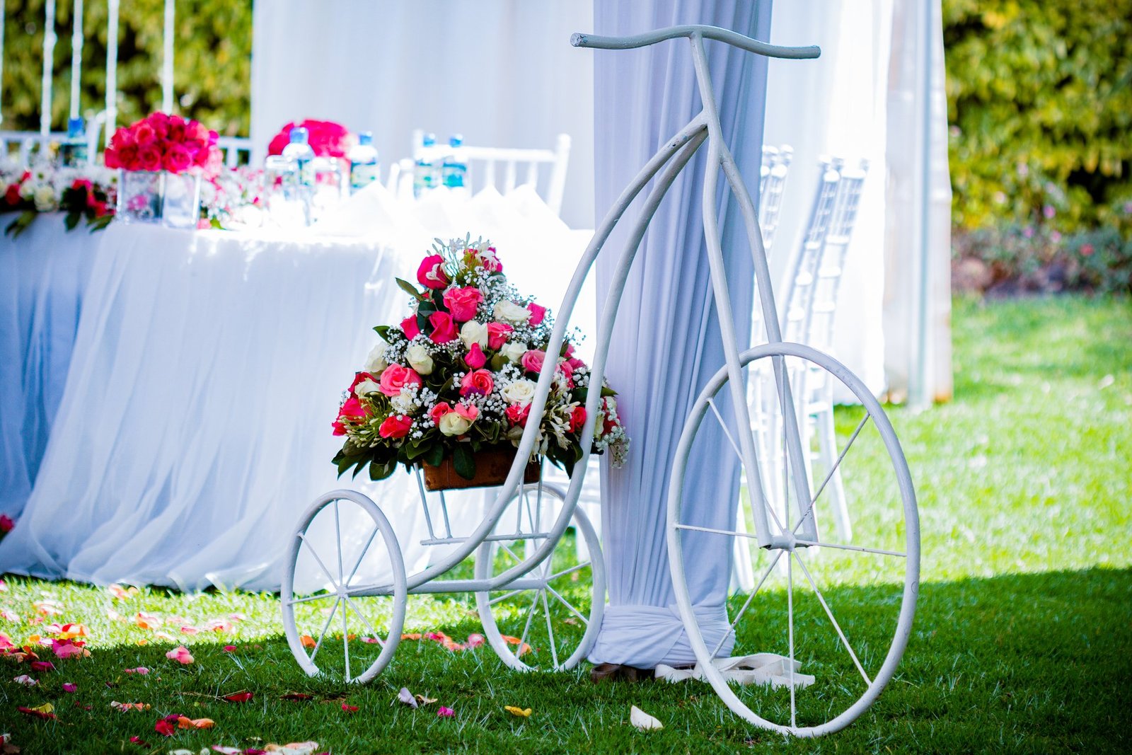 Elegant outdoor wedding ceremony tent decorated with flowers at a wedding venue