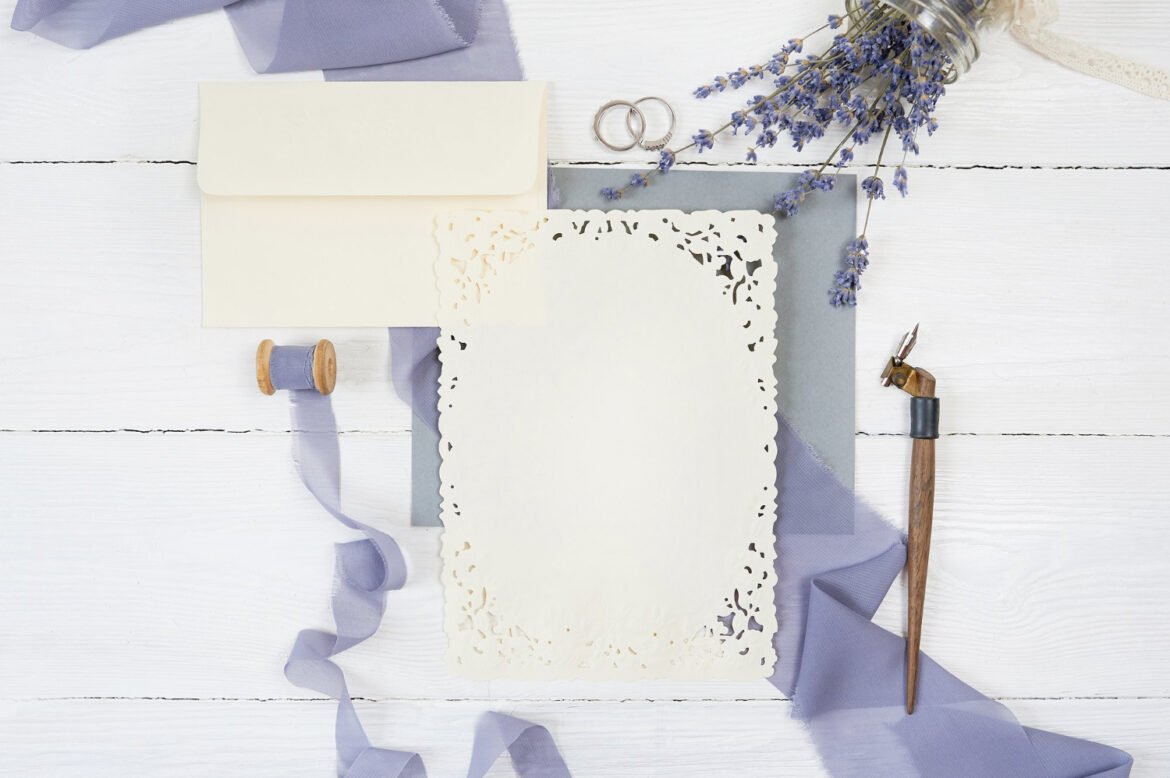 Elegant wedding invitation mockup with a calligraphy pen and lavender sprigs, reflecting refined wedding invitation wording