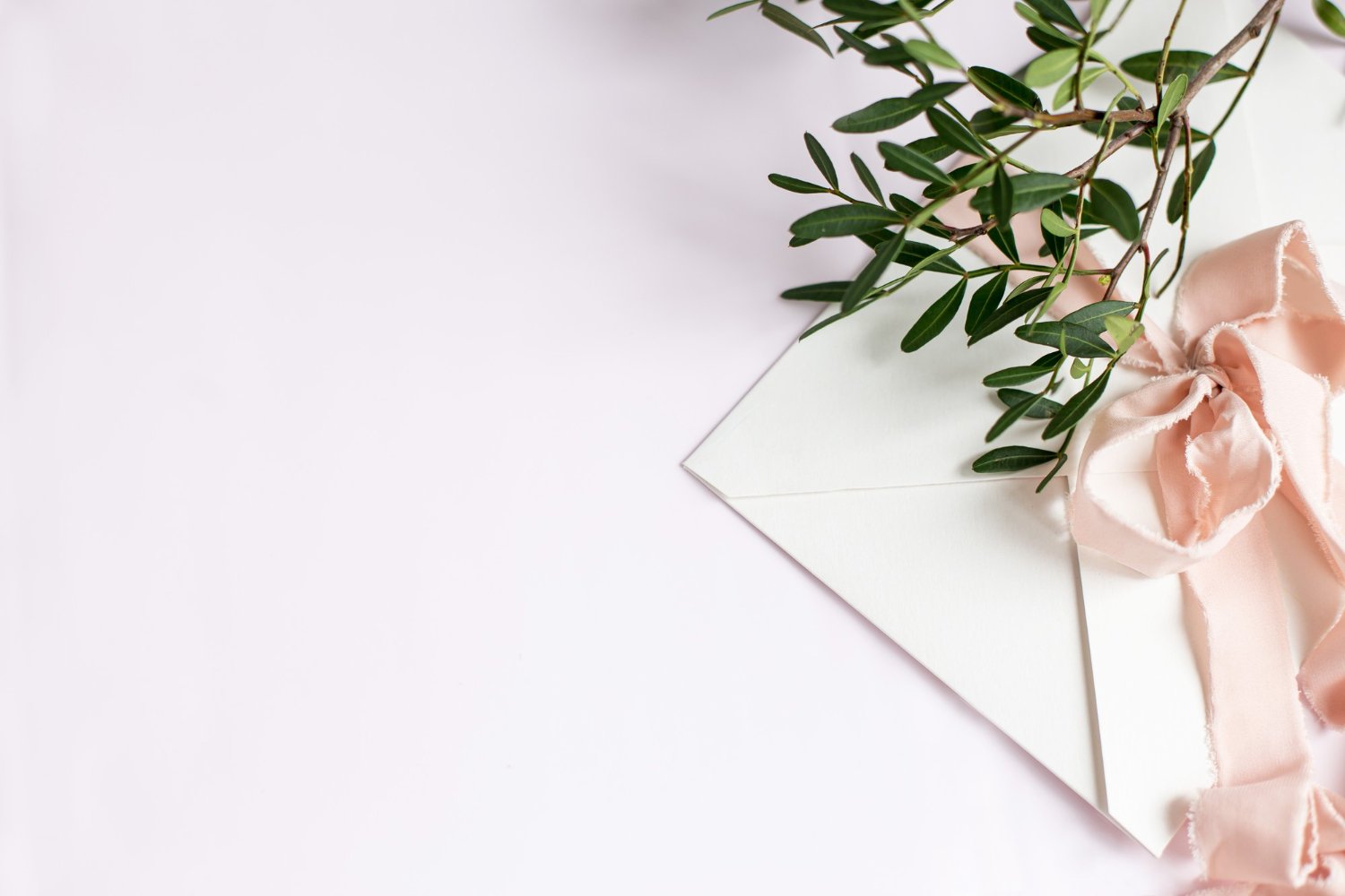 Wedding Officiant Cost: Hidden Fees and Questions to Ask Before You Book 6 Elegant wedding invitation envelope with peach silk ribbon and greenery