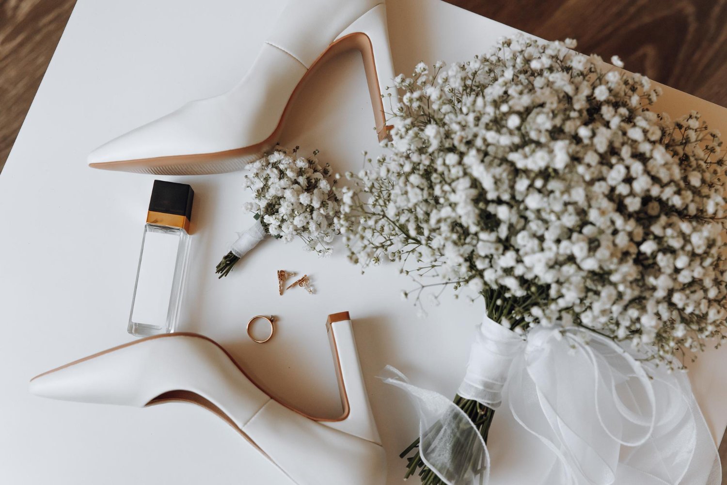 Wedding Vendor Tipping: Who to Tip, How Much, and When 8 Elegant bridal shoes, ring, and flowers flatlay for beauty and attire wedding vendors